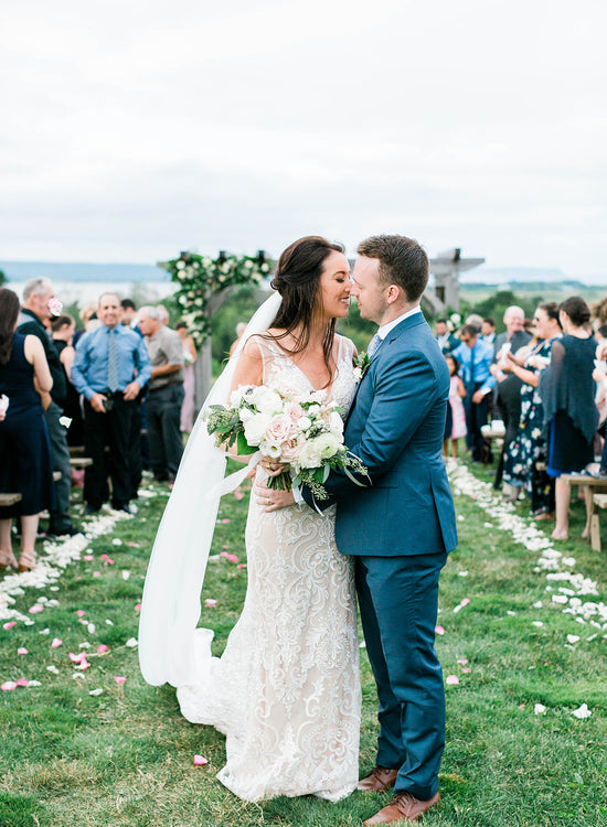 A couple about to kiss after getting married at Lightfoot & Wolfville.